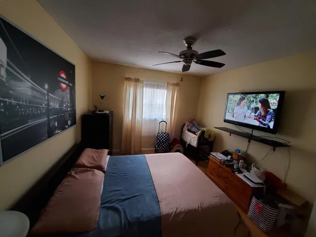 a bathroom with a sink a toilet and shower curtain