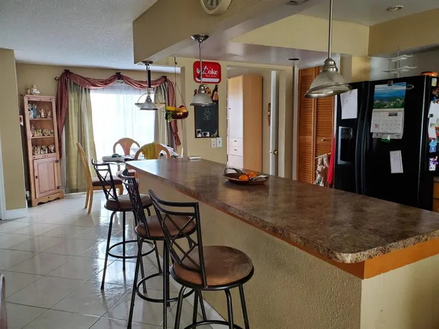 a kitchen with a sink stove top oven and cabinets
