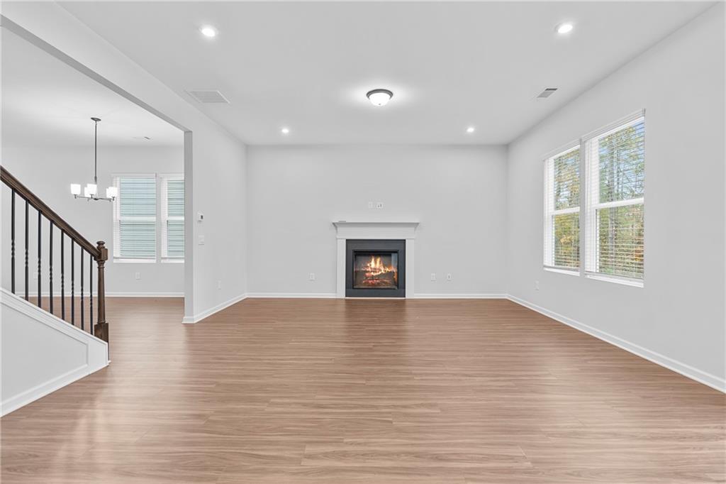 3699 Annsbury Court Lilburn, GA 30047 - Photo 12 of 45 an empty room with wooden floor and windows