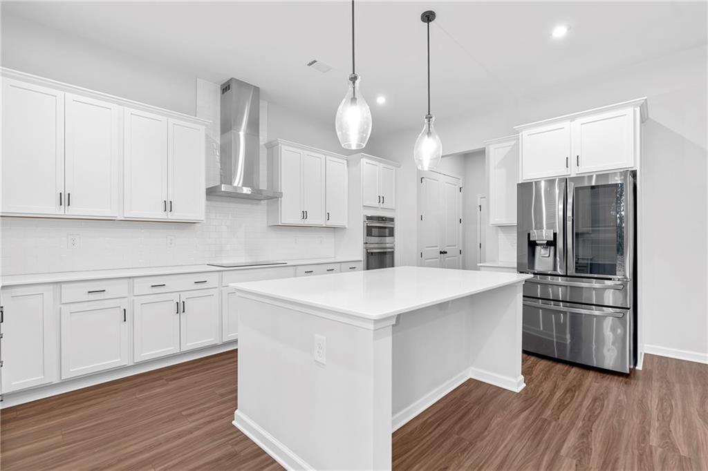 3699 Annsbury Court Lilburn, GA 30047 - Photo 14 of 45 a kitchen with white cabinets and stainless steel appliances