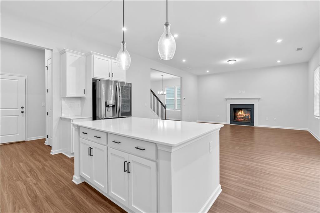 3699 Annsbury Court Lilburn, GA 30047 - Photo 15 of 45 a kitchen with stainless steel appliances a kitchen island hardwood floor and a sink