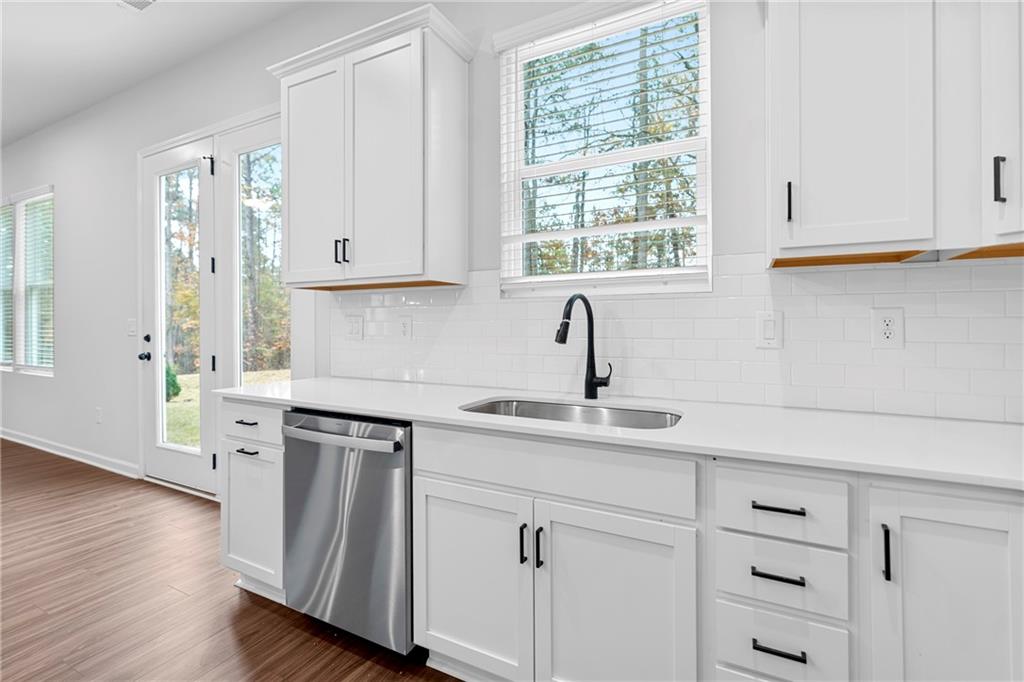 3699 Annsbury Court Lilburn, GA 30047 - Photo 17 of 45 a kitchen with cabinets appliances a sink and a window