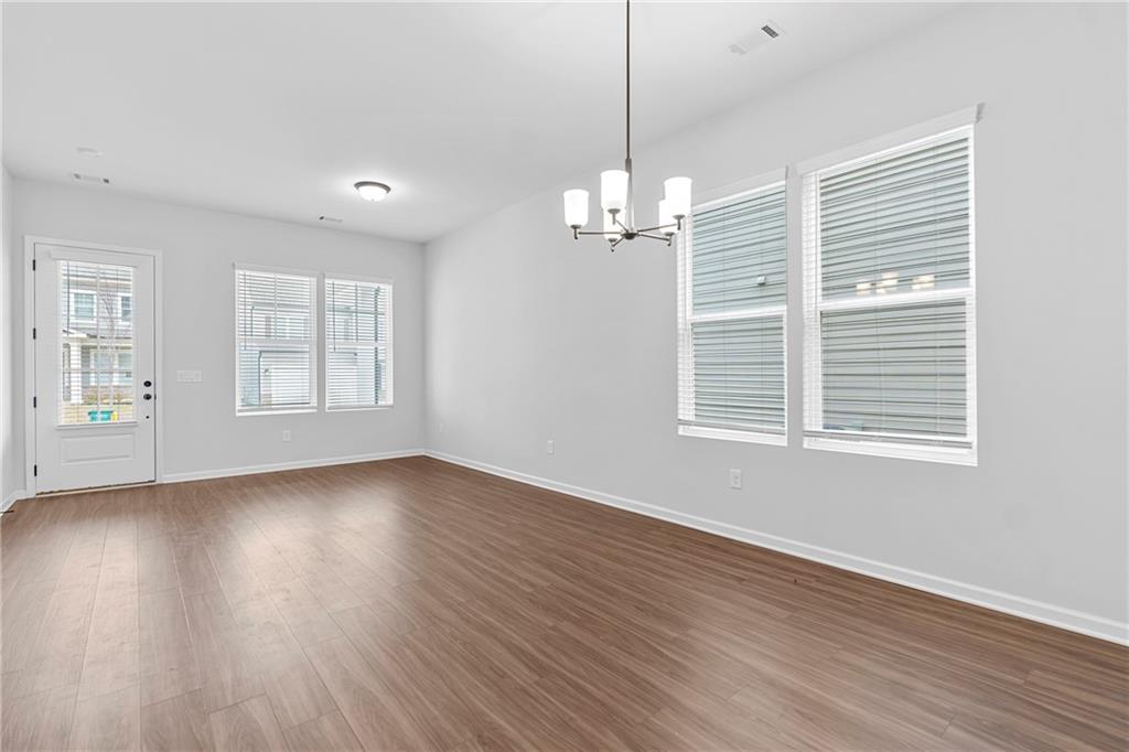 3699 Annsbury Court Lilburn, GA 30047 - Photo 19 of 45 a view of empty room with wooden floor and window