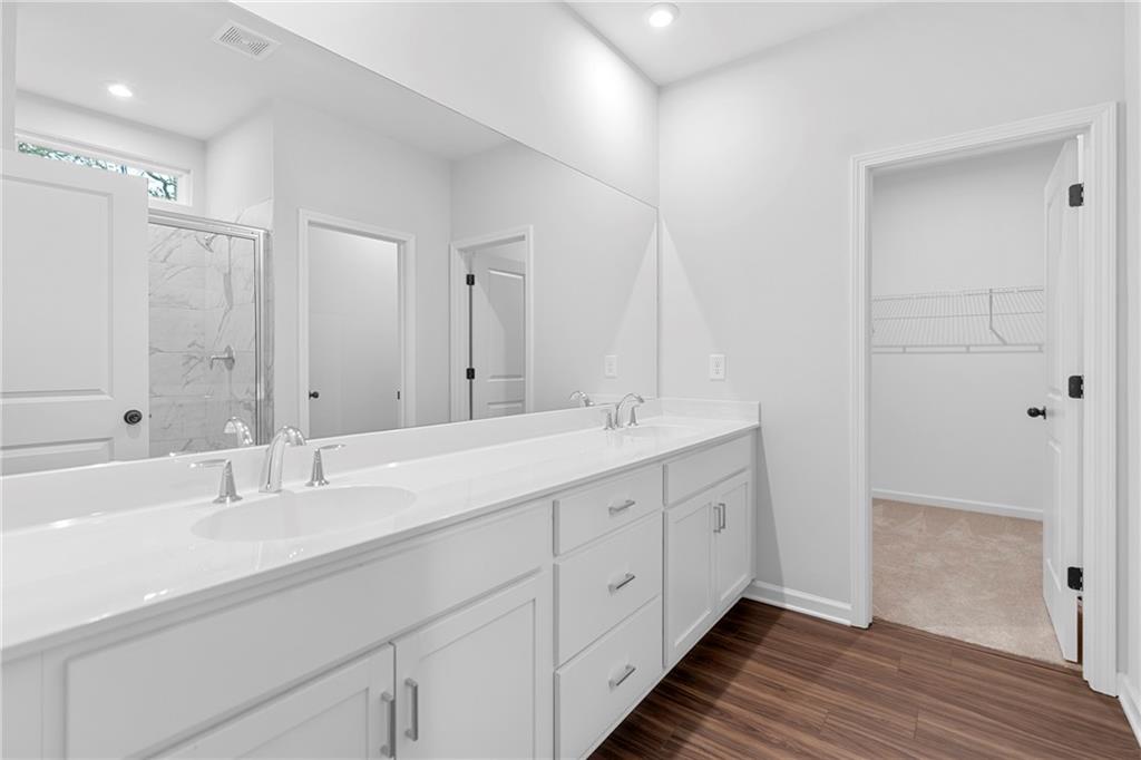 3699 Annsbury Court Lilburn, GA 30047 - Photo 27 of 45 a bathroom with double vanity sink and a mirror