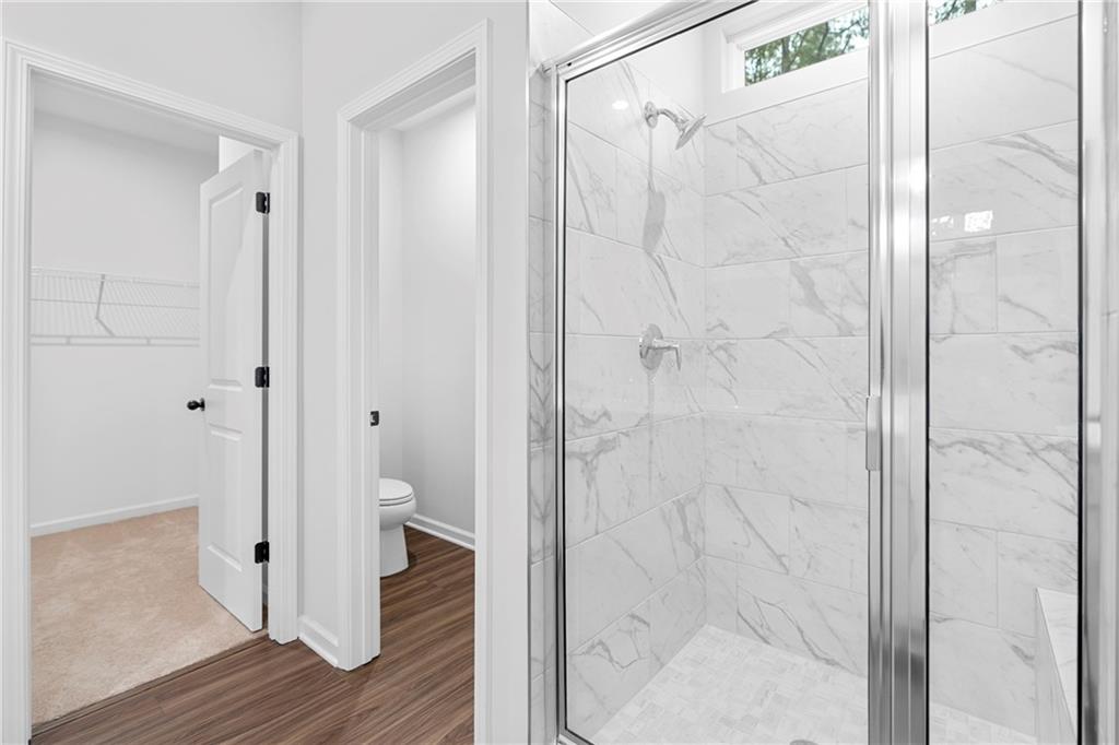 3699 Annsbury Court Lilburn, GA 30047 - Photo 29 of 45 a bathroom with a glass shower door