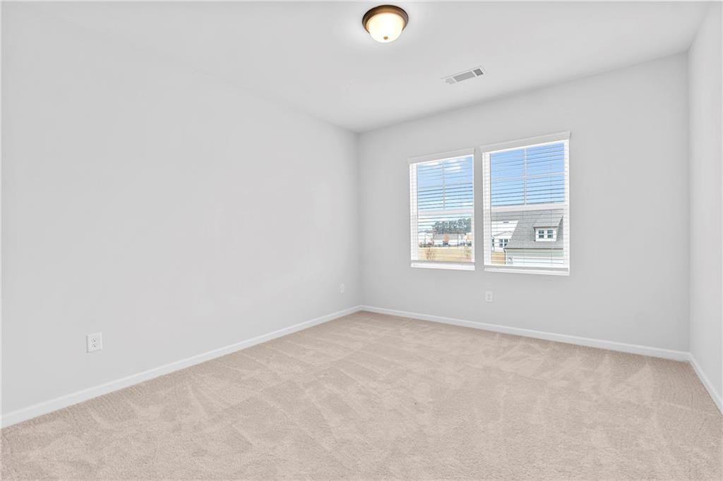 3699 Annsbury Court Lilburn, GA 30047 - Photo 30 of 45 an empty room with windows
