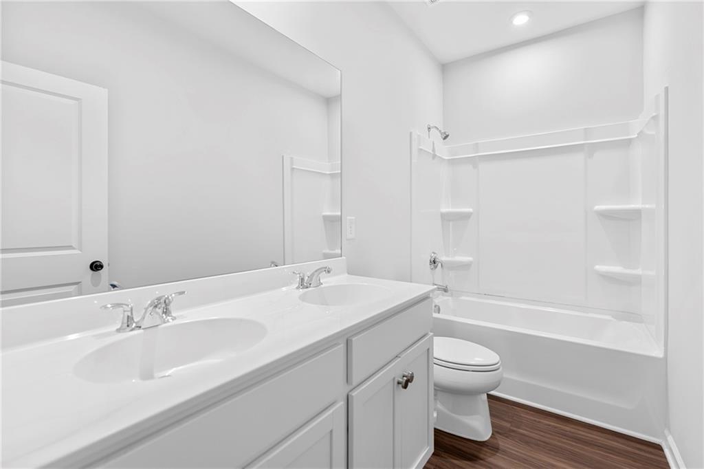 3699 Annsbury Court Lilburn, GA 30047 - Photo 35 of 45 a bathroom with a sink toilet vanity granite tub and shower