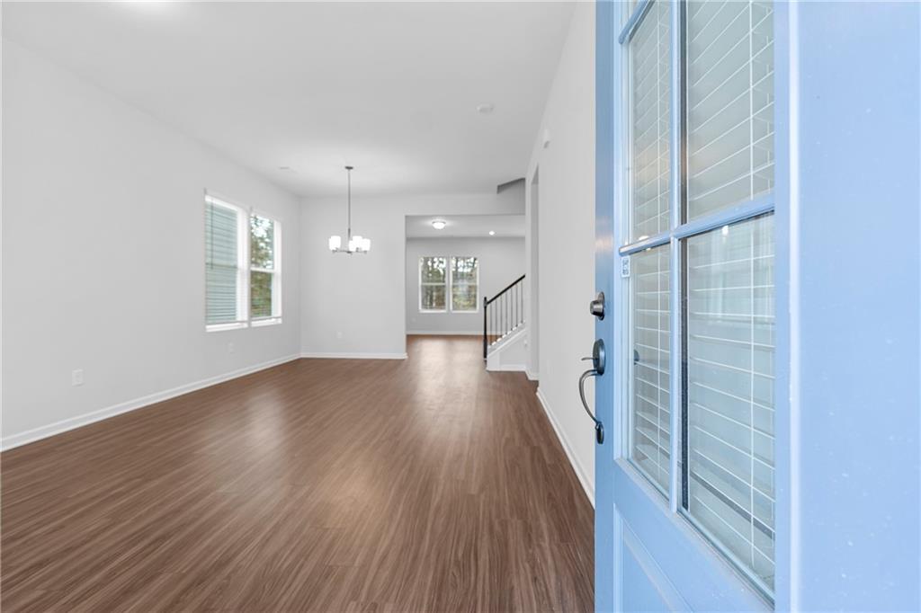 3699 Annsbury Court Lilburn, GA 30047 - Photo 4 of 45 a view of a hallway with wooden floor and a large window