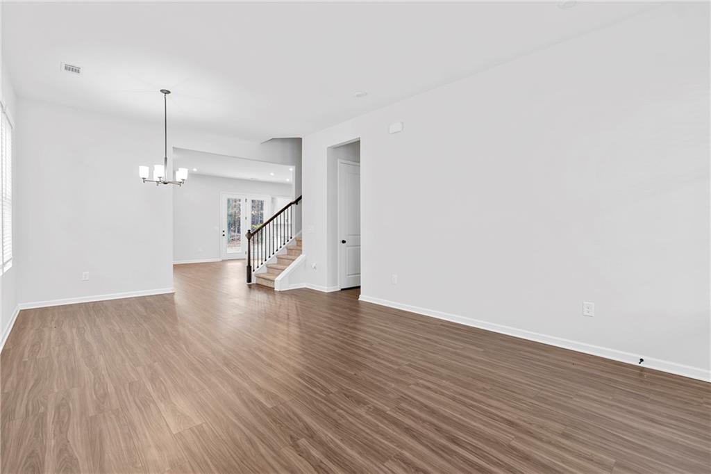 3699 Annsbury Court Lilburn, GA 30047 - Photo 5 of 45 a view of empty room with wooden floor and ceiling fan