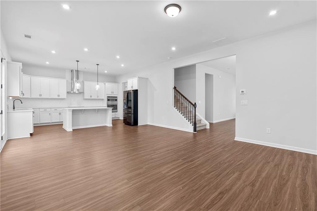 3699 Annsbury Court Lilburn, GA 30047 - Photo 10 of 45 a view of kitchen view wooden floor stainless steel appliances and cabinets
