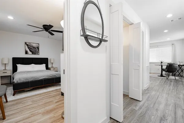 a bedroom with a bed and a mirror