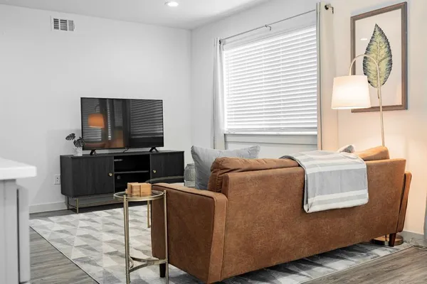 a living room with furniture and a flat screen tv