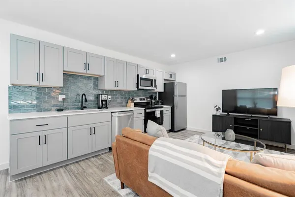 a kitchen with stainless steel appliances kitchen island granite countertop a sink and cabinets