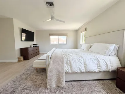 a bedroom with a bed and flat screen tv
