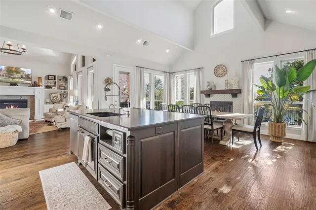 a kitchen with a stove and a wooden floor