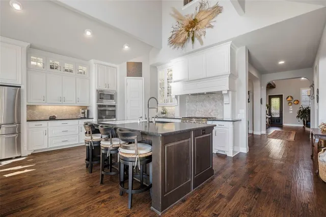 a kitchen with a table chairs stove and cabinets