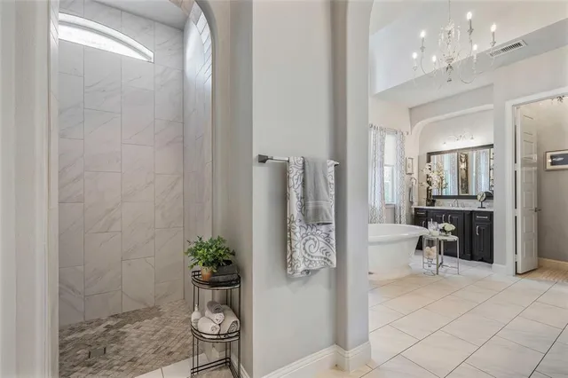 a bathroom with a potted plant and a shower