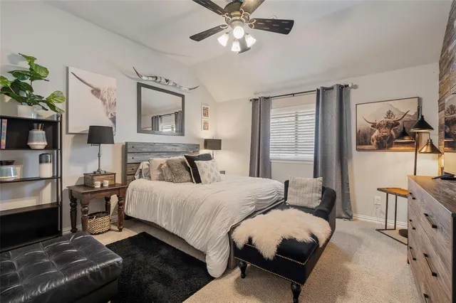 a bedroom with a bed a couch and dresser