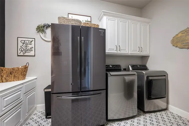 a metallic refrigerator freezer sitting in a kitchen