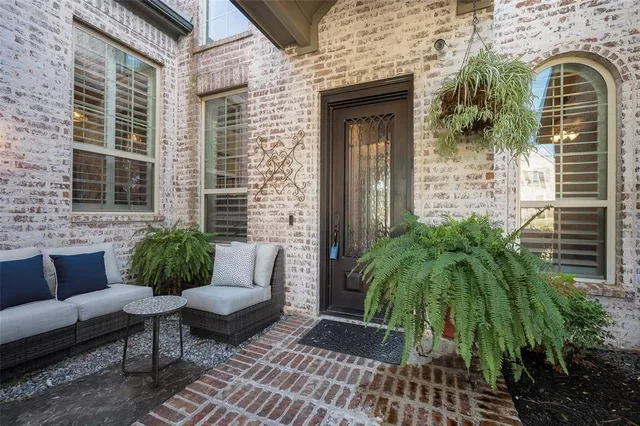 a view of a patio with couches table and chairs and potted plants
