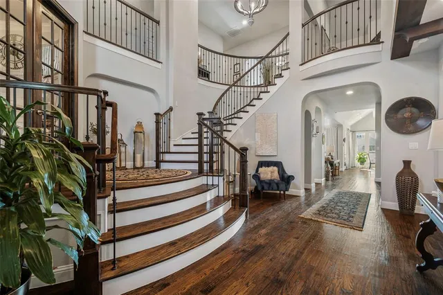 a view of entryway and hall with wooden floor
