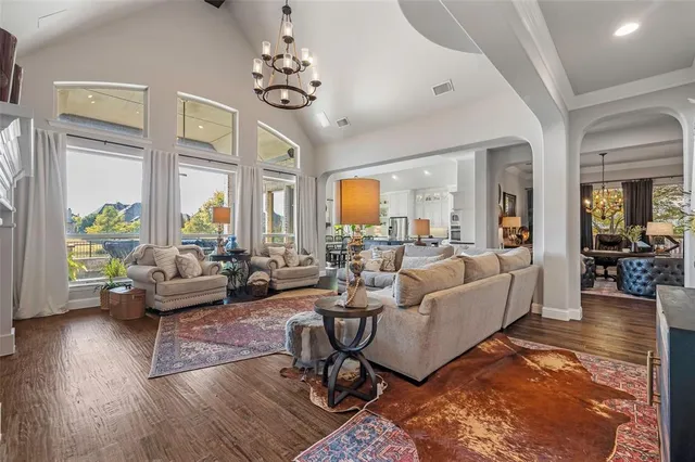 a living room with fireplace furniture and a large window