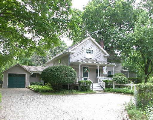 25 Seeley Road Wilton, CT 06897 - Photo 1 of 1 a front view of a house with a garden and trees