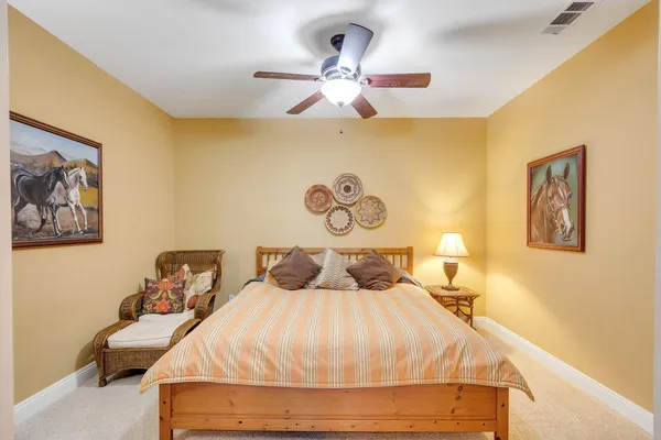 a spacious bedroom with a bed and a chandelier