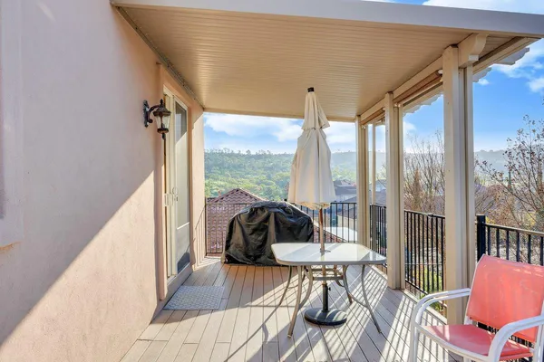 a view of a patio with a table and chairs