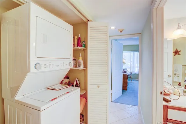 a hallway with furniture and a potted plant