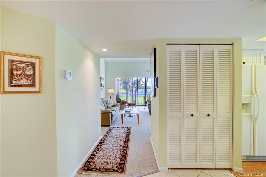 233 Northeast Edgewater Drive, Unit 204 Stuart, FL 34996 - Photo 13 of 56 a hallway with furniture and a potted plant