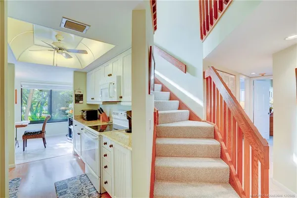 a kitchen with stainless steel appliances granite countertop a sink a stove and a refrigerator