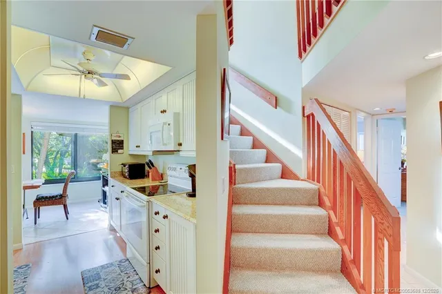 a kitchen with stainless steel appliances granite countertop a sink a stove and a refrigerator