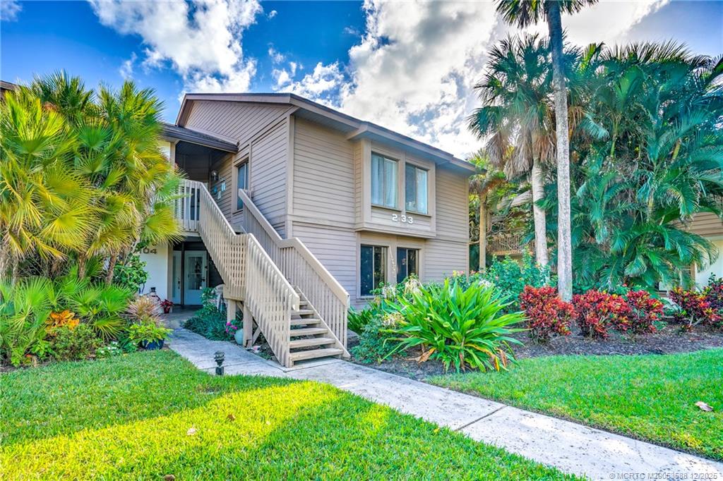 233 Northeast Edgewater Drive, Unit 204 Stuart, FL 34996 - Photo 2 of 56 a view of a house with a yard and plants