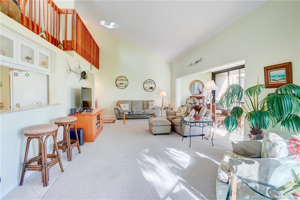 233 Northeast Edgewater Drive, Unit 204 Stuart, FL 34996 - Photo 22 of 56 a living room with furniture and a potted plant
