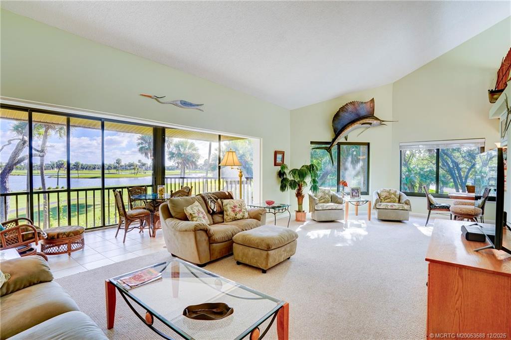233 Northeast Edgewater Drive, Unit 204 Stuart, FL 34996 - Photo 24 of 56 a living room with furniture and a large window