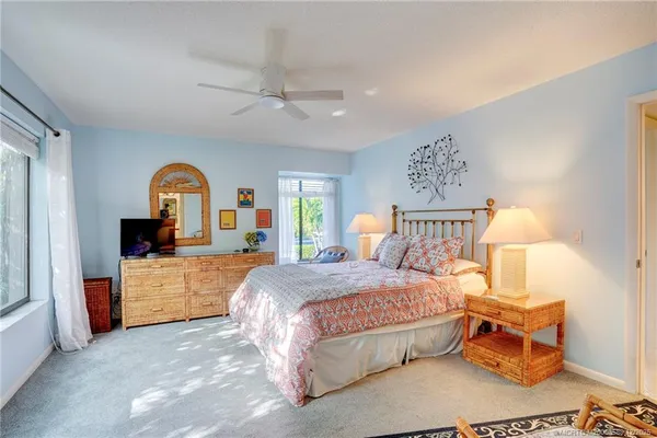 a bedroom with a large bed and a large window