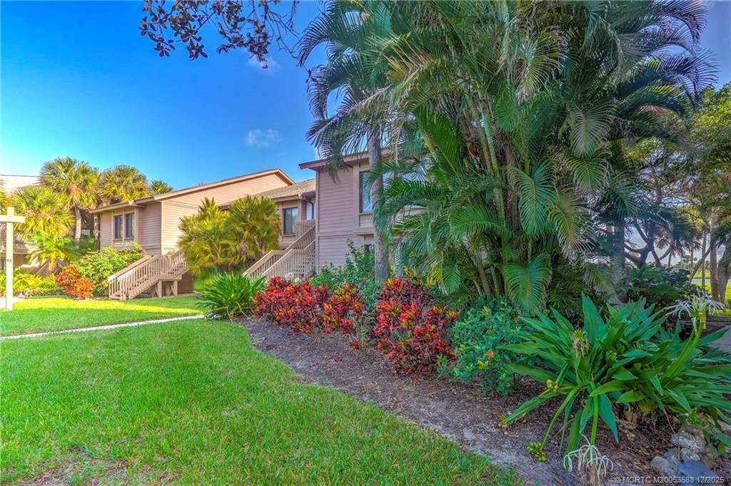233 Northeast Edgewater Drive, Unit 204 Stuart, FL 34996 - Photo 3 of 56 a view of a garden with a building in the background