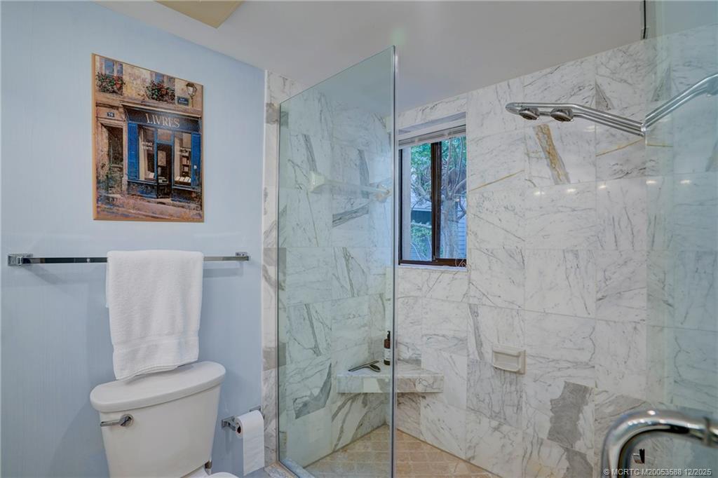 233 Northeast Edgewater Drive, Unit 204 Stuart, FL 34996 - Photo 34 of 56 a bathroom with a toilet sink and shower