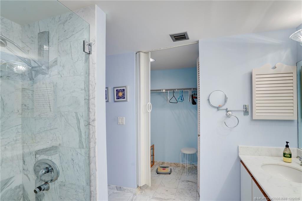 233 Northeast Edgewater Drive, Unit 204 Stuart, FL 34996 - Photo 35 of 56 a bathroom with a sink a toilet and shower