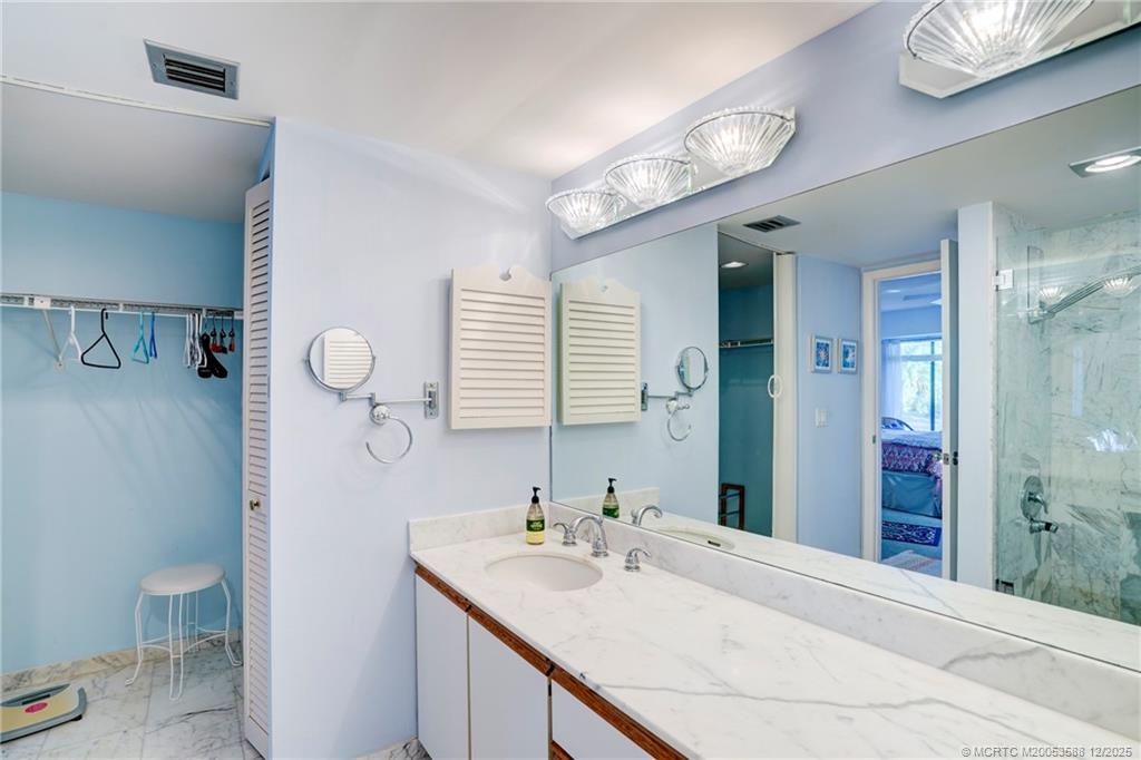 233 Northeast Edgewater Drive, Unit 204 Stuart, FL 34996 - Photo 36 of 56 a bathroom with a sink a toilet and shower