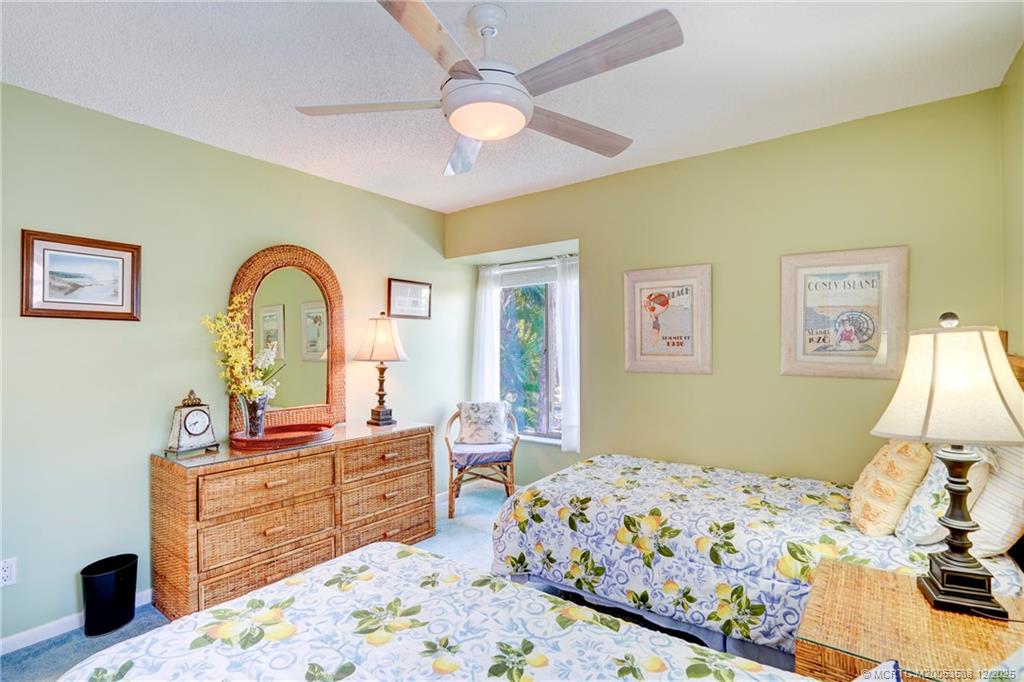 233 Northeast Edgewater Drive, Unit 204 Stuart, FL 34996 - Photo 38 of 56 a bedroom with a bed and a dresser