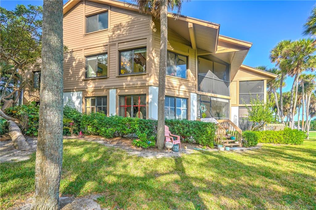 233 Northeast Edgewater Drive, Unit 204 Stuart, FL 34996 - Photo 4 of 56 a front view of a house with a yard