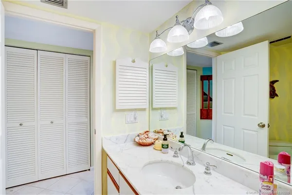 a view of a hallway with wooden floor and furniture