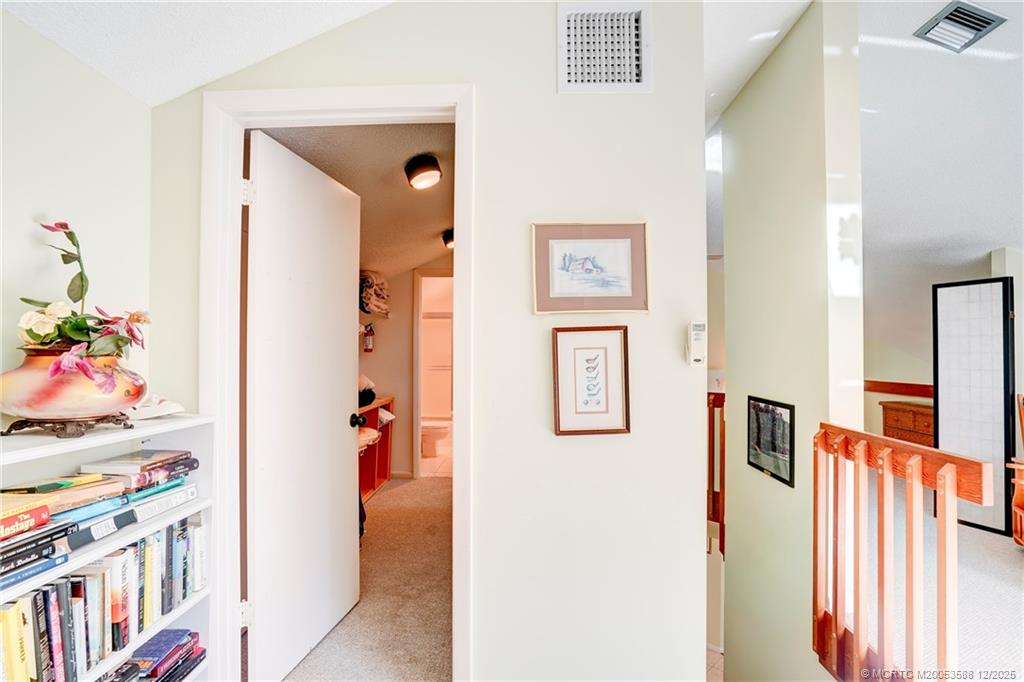 233 Northeast Edgewater Drive, Unit 204 Stuart, FL 34996 - Photo 43 of 56 a view of a hallway with wooden floor and furniture