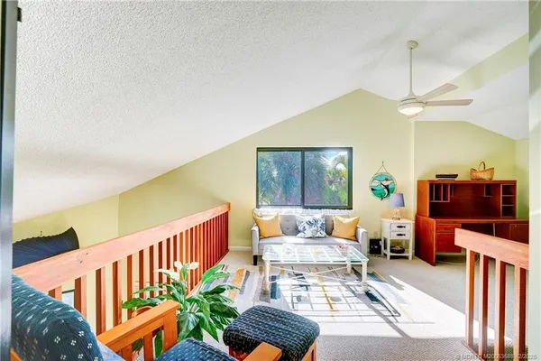 a bedroom with a bed and a chandelier fan