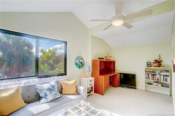 a bedroom with a bed closet and a flat tv screen
