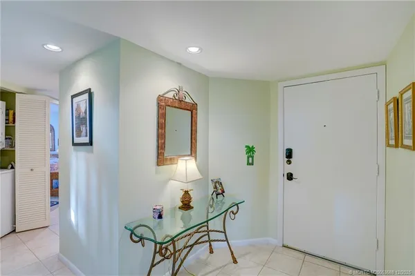 a view of hallway with stairs and wooden floor