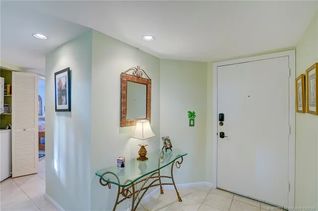 a view of hallway with stairs and wooden floor