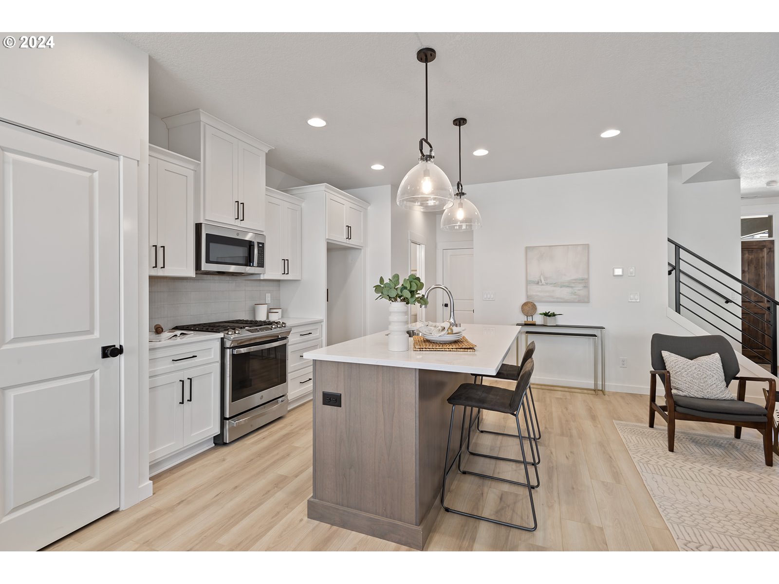 820 Northwest 178th Street Ridgefield, WA 98642 - Photo 15 of 45 a kitchen with kitchen island granite countertop stainless steel appliances a stove a sink a oven a dining table and chairs